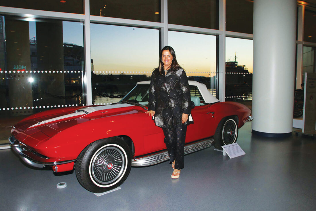 Barbara-Orbison-stands-next-to-husband-Roy's 1967 Chevrolet Corvette at the Rock & Roll Hall of Fame